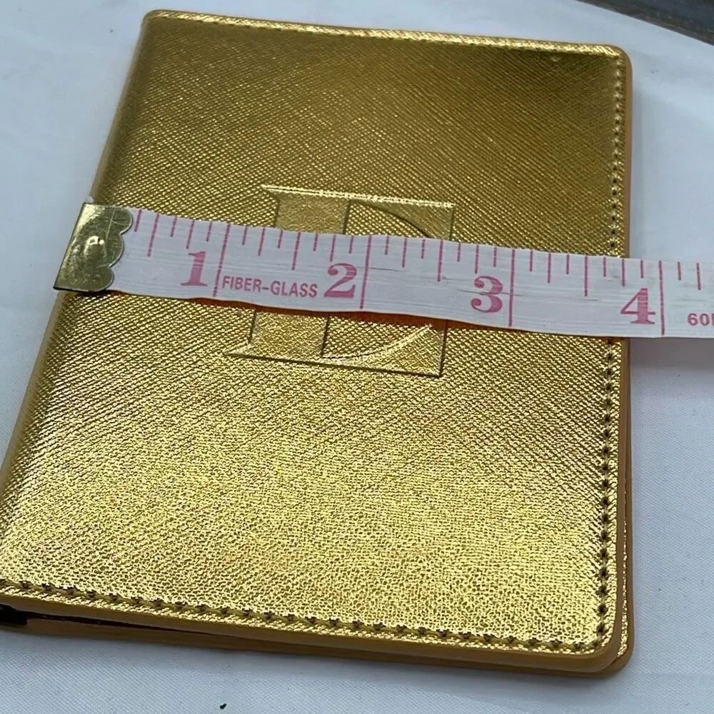 Vintage Elton John gold colored passport cover.